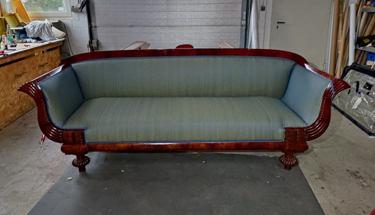 Biedermeier-Sofa mit neu bezogenem blau-grün gestreiftem Streifenstoff in der Polsterwerkstatt